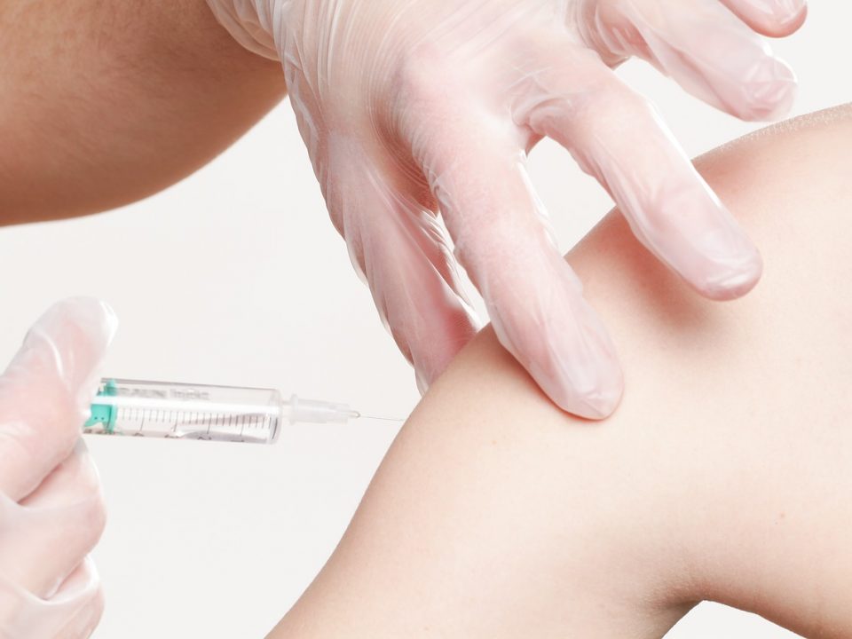 Médecin généraliste qui vaccine un enfant contre la grippe
